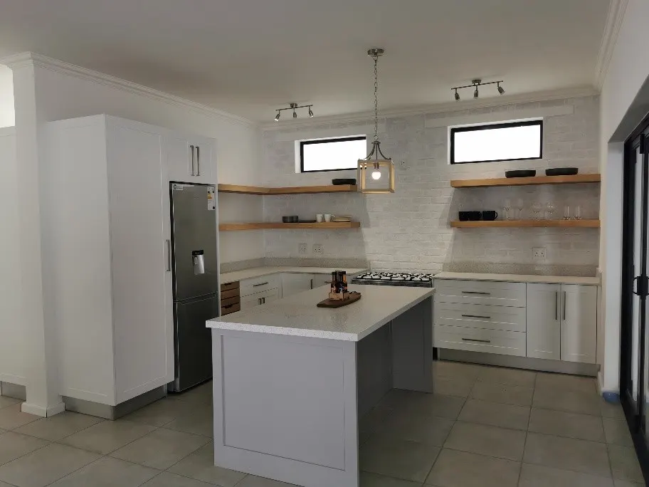 A compact pale island with open shelving