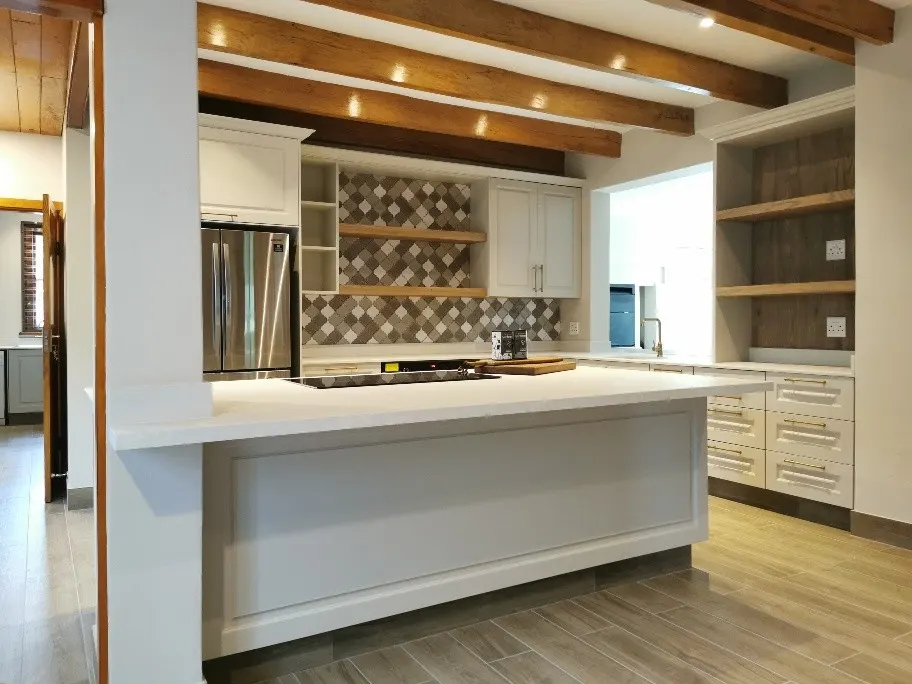 Pale stone and patterned tiles in a country kitchen