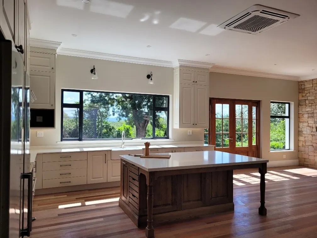 Stone countertops around a timber island